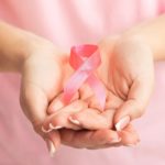 Unrecognizable Woman Showing Pink Breast Cancer Ribbon, White Background, Panorama