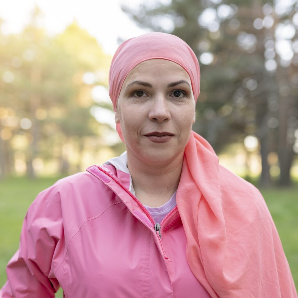 portrait of pretty mature woman, breast cancer survivor with chemotherapy scarf, looking at camera