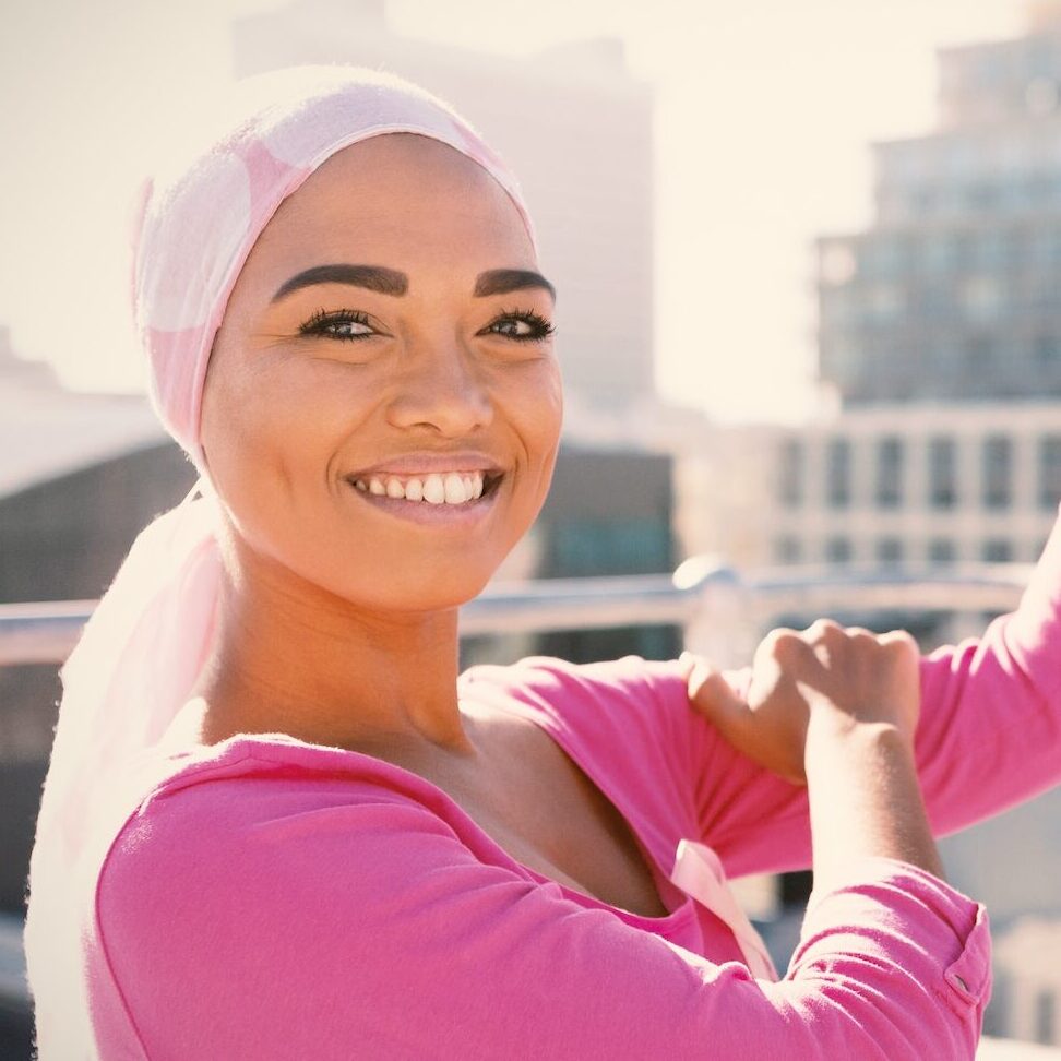 Strong woman in city with breast cancer awareness